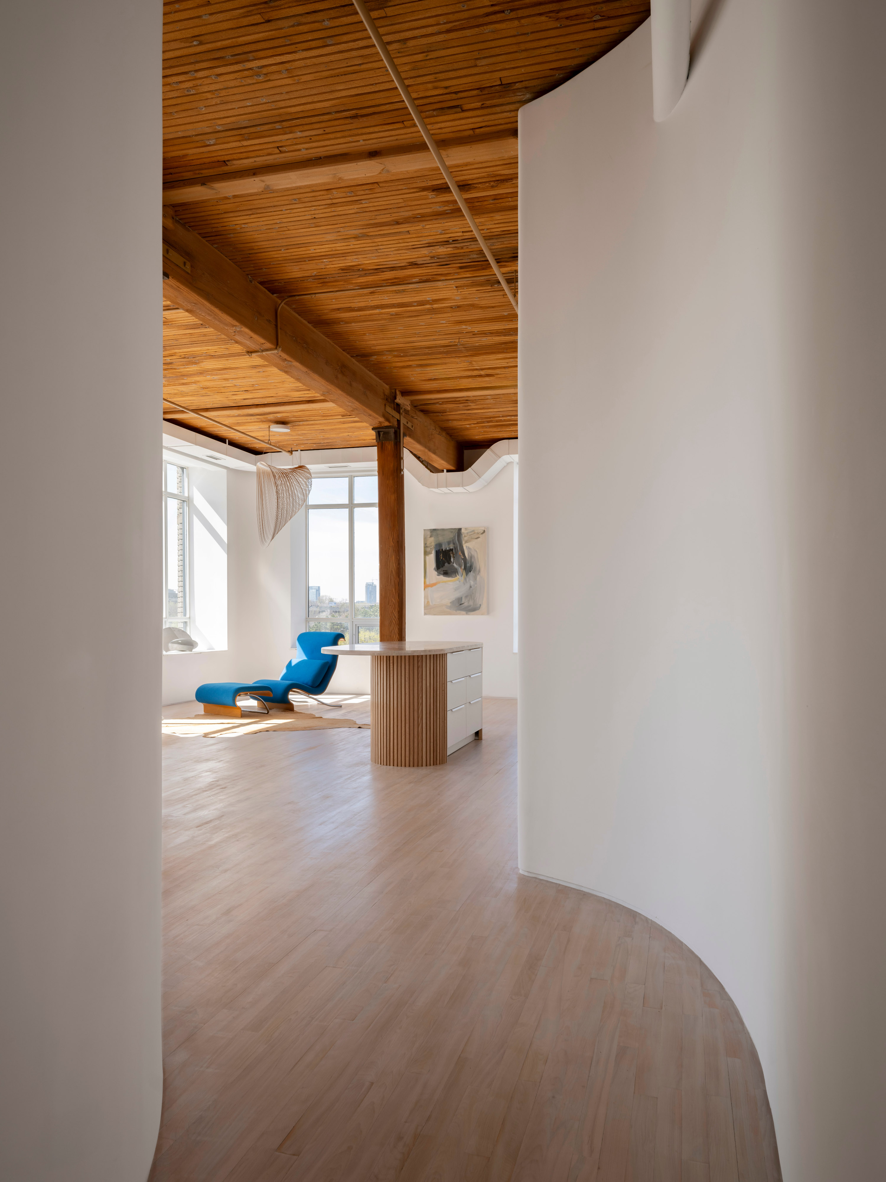 The curved wall shapes and directs the space